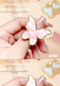 Detailed macro view of pink butterfly resin nail art palette ring with golden edges