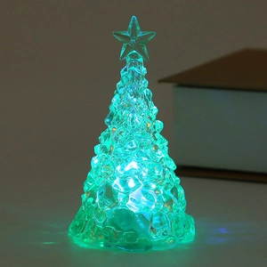 Close-up of a glowing green LED Christmas tree light with diamond-cut crystal texture