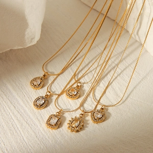 Macro shot of 18K gold plated stainless steel necklaces with various crystal pendants