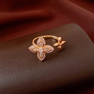 Macro detail of gold flower ring with cubic zirconia on brown leather display stand