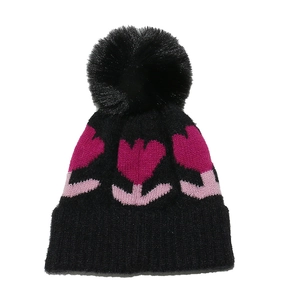 Detail of knitted baby winter hat with pink tulip embroidery and black faux fur pom-pom