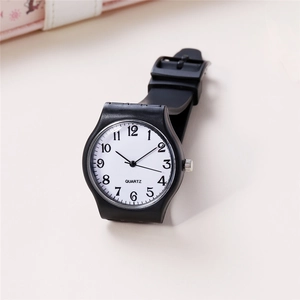 Detail of minimalist black quartz watch with white dial and clear Arabic numerals