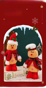 Close-up of knitted gingerbread dolls with red hats and scarves for Christmas decor