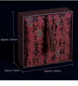 Detail view of red brocade gift box with Chinese calligraphy and dark base, 120x120x43mm