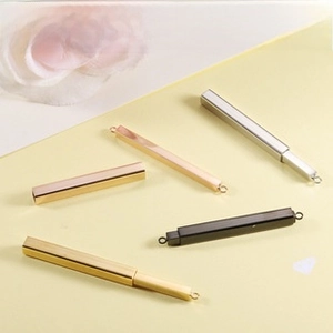 Detailed view of polished stainless steel bar pendants in gold silver black and rose gold