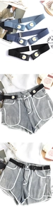 Detail of buckle-free elastic belts with daisy flower accents in blue and black colors