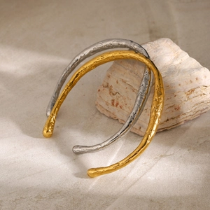 Irregular 18k gold and silver hammered stainless steel open bracelets on stone