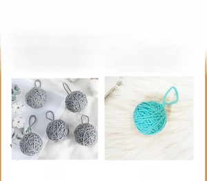 Close-up of gray and blue wool yarn ball ornaments with hanging loops for DIY crafts