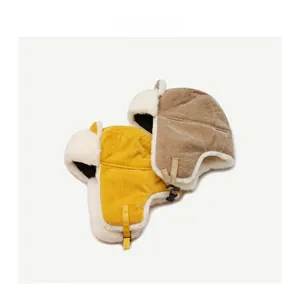 Detailed top view of corduroy aviator hats in yellow and khaki with white fleece lining