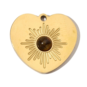 Detail of heart-shaped gold titanium steel pendant with sunburst texture and tiger eye stone