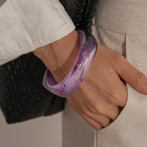 Close-up of purple marble resin chunky bangle on wrist with aesthetic lifestyle styling