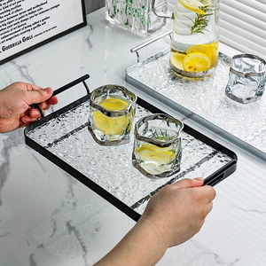Rectangular hammered glass tray with black metal frame and handles for fruit or drinks