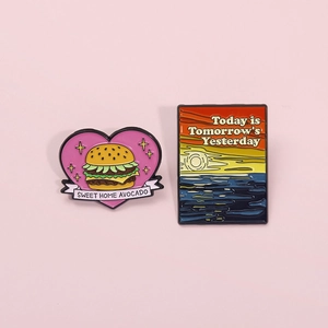 Cartoon heart burger and sunset sea landscape enamel pins on a soft pink background