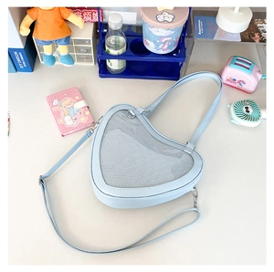Light blue heart-shaped Ita bag with clear window for badges and adjustable strap