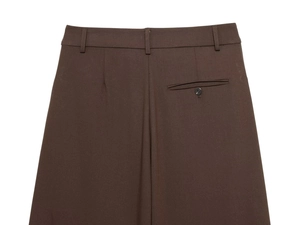 Detail of dark brown trousers featuring belt loops and a functional back pocket detail