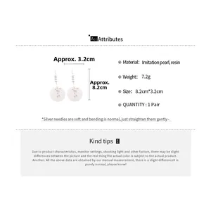 Detailed view of long imitation pearl and resin drop earrings with size measurements