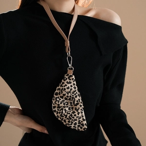 Detail of leopard print croissant mini bag necklace with silver hook and leather strap