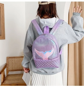 Detail of laser shiny mermaid backpack showing purple fish scale texture and embroidery