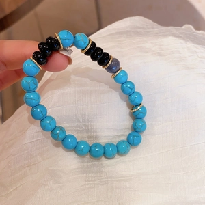 Detailed close-up of mixed beads bracelet featuring blue turquoise and black onyx stones