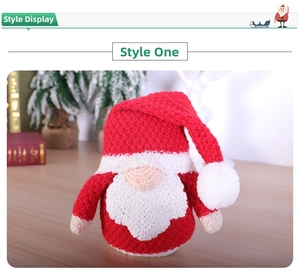 Close-up of knitted Christmas gnome with red hat and white beard in festive setting