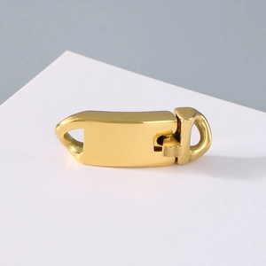 Close-up of golden stainless steel Cuban chain clasp with a polished metallic finish