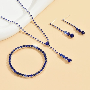 Detailed view of silver wedding jewelry set with sparkling blue round-cut gemstones