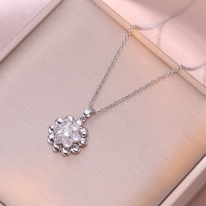 Elegant rotating sunflower necklace with white zircons in a silver finish