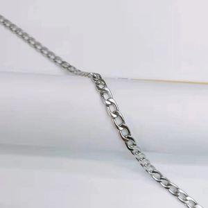 Macro shot of a silver Cuban link chain necklace with polished stainless steel texture