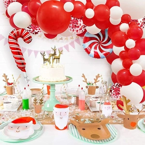 Detailed close-up of Christmas party set with red and white balloons and holiday tableware