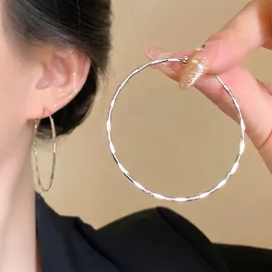 Silver-toned large hoop earrings with hammer textured finish for a minimalist style