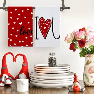 Absorbent red and white kitchen towels with heart patterns and love text in cozy home setting