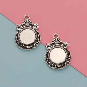 Close-up of 12mm silver-tone ocean moon scale pendant charms for DIY jewelry making