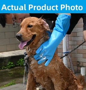 Blue waterproof pet bathing gloves with massage bristles used on a Golden Retriever