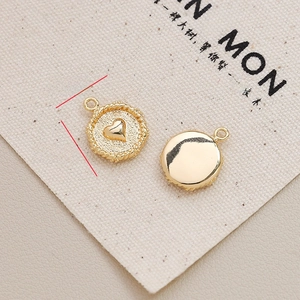 Detailed macro view of 12mm gold plated heart pendants for DIY jewelry making