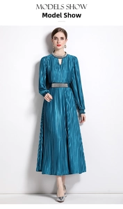Detailed view of beaded rhinestone trim on the neckline of a pleated midi dress