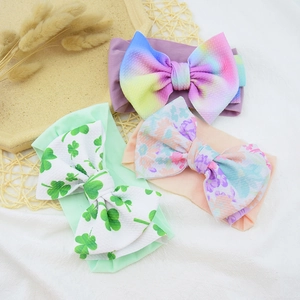 Detail of baby nylon headbands with floral, rainbow, and clover printed large bows