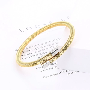 Detail of golden woven mesh stretch bracelet with silver cylindrical metal ends