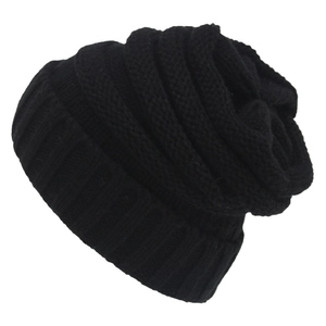 Solid black knitted slouchy beanie for winter with thick ribbed cuff on white background
