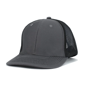 Close-up of the breathable polyester mesh and stitching on a dark grey trucker hat
