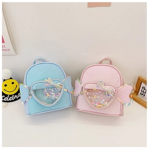 Close-up of pink and blue sequin backpacks with heart sand pockets and glitter wings
