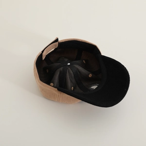 Detail showing the inner black lining, sweatband and adjustable strap of corduroy cap