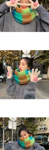 Detail of colorful plaid scarf and white plush gloves with pink heart embroidery