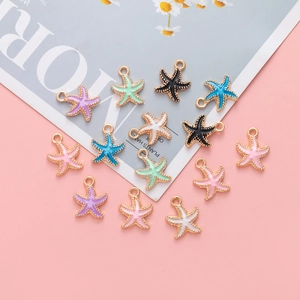 Detailed view of colorful oil-dripping starfish alloy pendants on a pink background