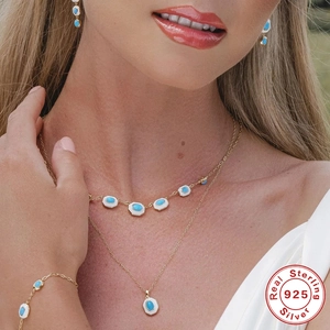 S925 sterling silver jewelry set with turquoise stones and white enamel finish on model