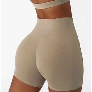 Detail of high-waisted yoga shorts with side pocket and peach lift stitching