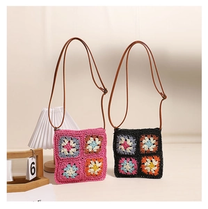 Detail of crochet sunflower crossbody bags in pink and black with leather straps