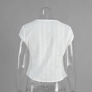 Detail view of the white V-neck top's back featuring a vertical striped fabric texture