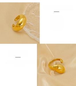 Detailed view of chunky golden stainless steel open ring on warm satin background