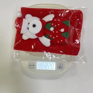 Macro view of Santa-themed brushed fabric wine bottle cover weighing 22.0g on digital scale