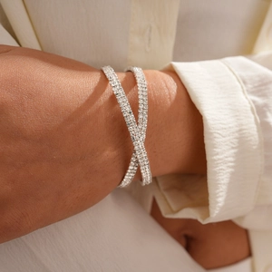 Detailed view of silver crossover bracelet featuring pave-set sparkling rhinestones